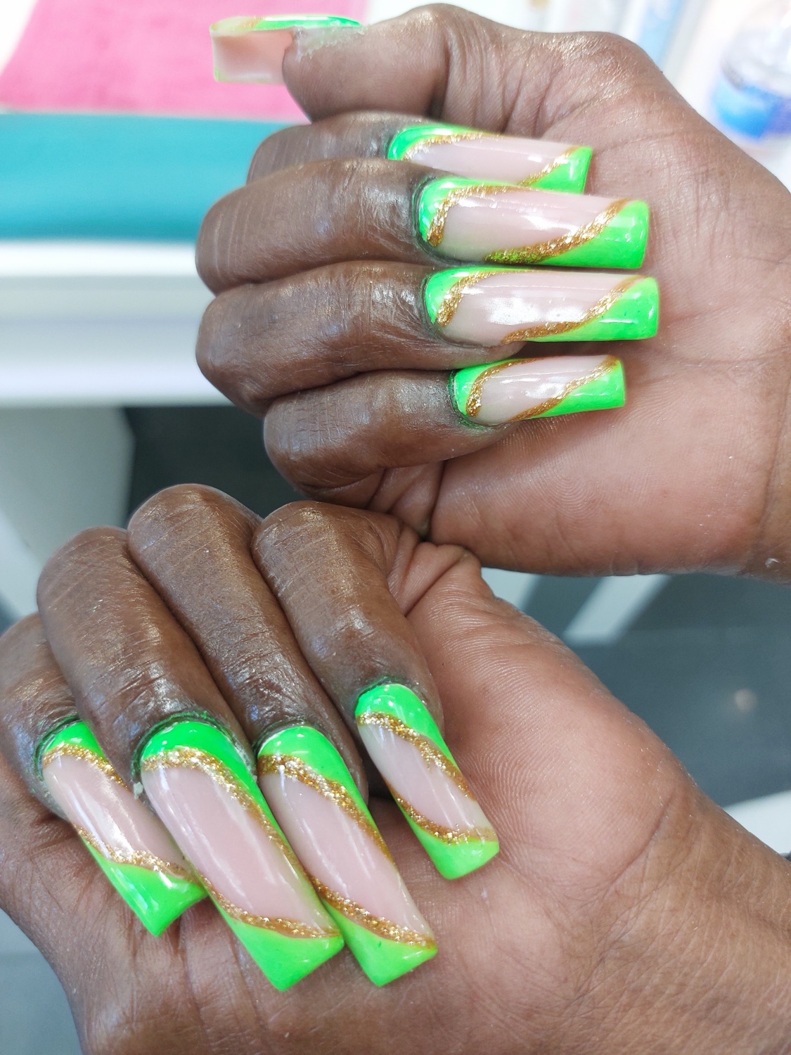 Neon green and gold hand-painted acrylic nail art created at Skye Nails Spa and Beauty, Hackney
