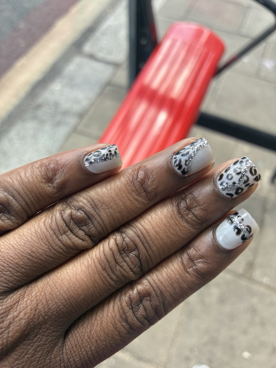 White and grey leopard-print nails with silver glitter