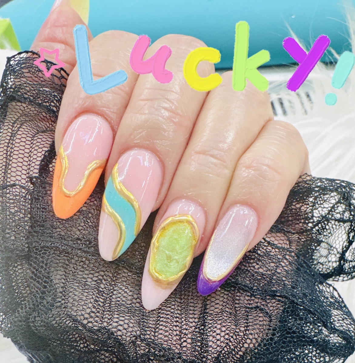 Rainbow swirl acrylic nails with gold outlines
